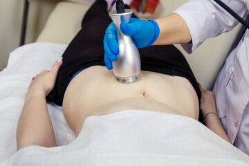 Anti-cellulite massage in the abdomen in a beauty parlor.