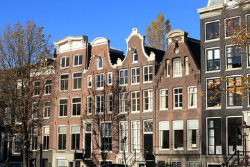 Fototapeta premium Amsterdam Prinsengracht Canal Traditional Brick House Facades with Various Gables and Blue Sky, Netherlands