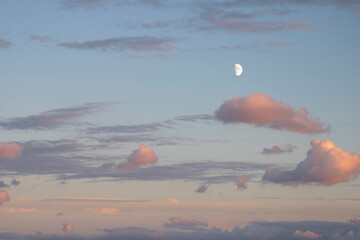 Sky with clouds and  moon, pastel colors. Pale and soft colors. Sky and full moon background.