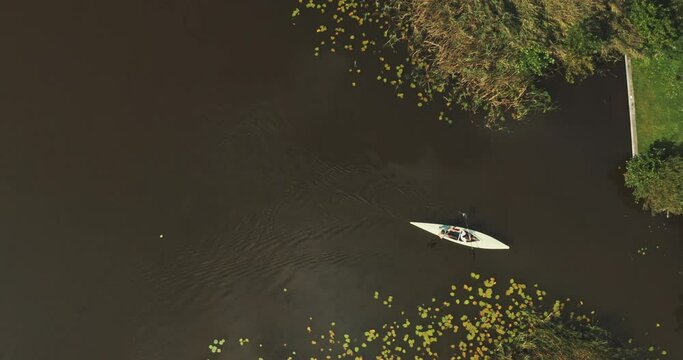 Top drone hot of two wite canoes paddling
