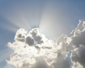 Fototapeta na wymiar Beautiful fluffy clouds and rays of sunshine in sunny day. Atmosphere background or wallpaper