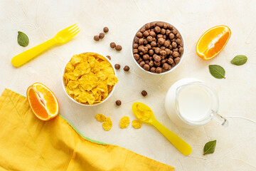 Children breakfast with snack - cereals with oranges, top view