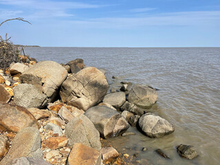 Rocky section of the shore of Lake Khanka in autumn. Russia, Primorsky Krai