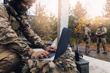 Soldier engineer use laptop for transmits aerial photo and data from drone to headquarters...