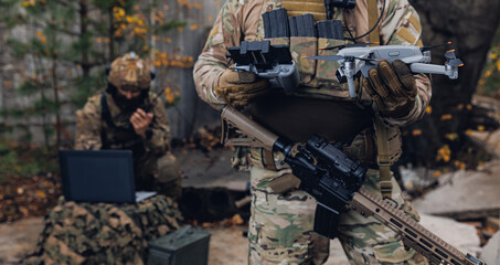 Army soldier holds drone for use in war, special reconnaissance operation.