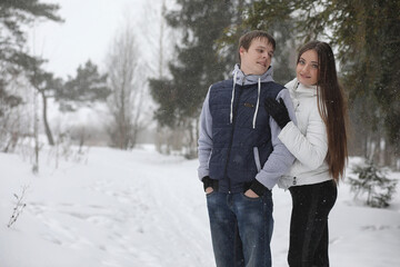 pair of lovers on a date winter afternoon in a snow blizzard