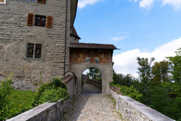 Fototapeta na wymiar Kyburg castle with stone gate,, stone bridge and coat of arms on a sunny late summer day. Photo taken September 1st, 2022, Kyburg, Switzerland.