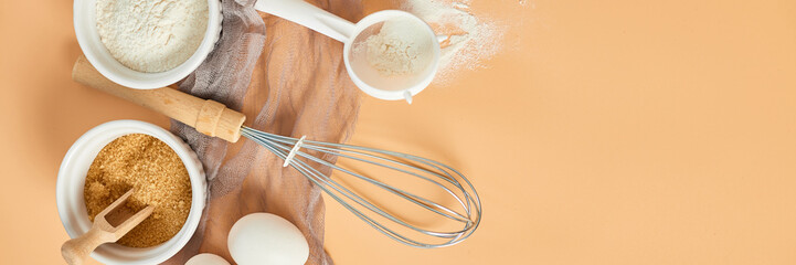 Banner Bakery  or cooking frame, ingredients, kitchen items for pastry on pastel orange background. Top view, copy space.
