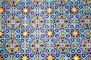 Traditional uzbek pattern on the ceramic tile on the wall of the mosque.
