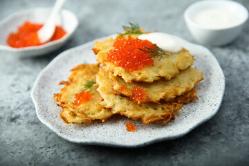 Homemade latkes with red caviar
