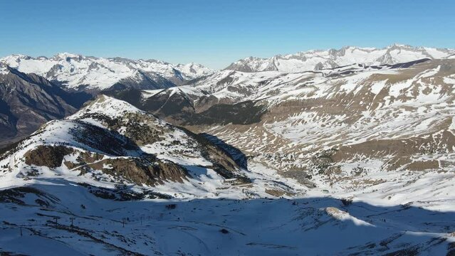 Aerial walkthrough Aram&oacute;n Cerler ski resort. Stunning background with snowy mountains