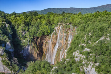 Fototapeta na wymiar Majestic view of biggest waterfall with crystal clear water in forest in The Plitvice Lakes National Park in Croatia Europe.