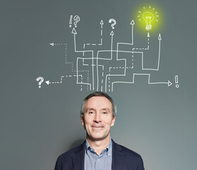 Idea concept. Mature businessman with light bulb and lines