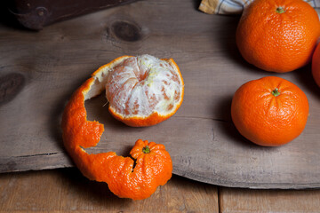 Fresh orange ripe mandarins or tangerines on wooden board.