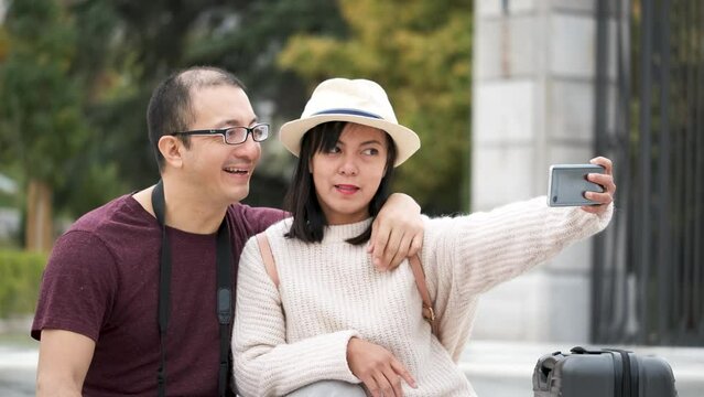 Happy multiracial couple of tourists taking a selfie together. Sightseeing in Madrid, Spain.