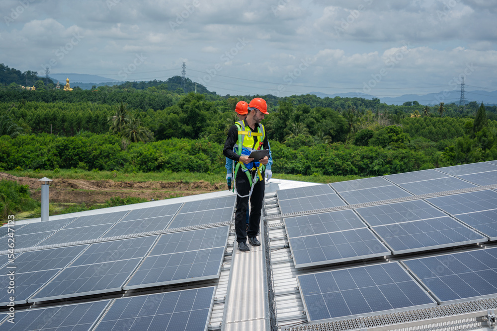 Poster solar power,engineer inspect solar panels on the roof of a factory where solar panels are installed 