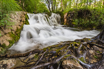 Majestic view of waterfall with crystal clear water in forest in The Plitvice Lakes National Park...