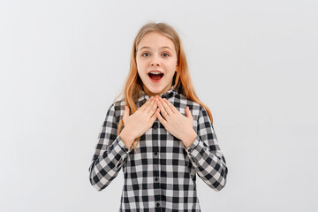 Enthusiastic teen girl, looking surprised and amazed, impressed reaction, standing in casual plaid...