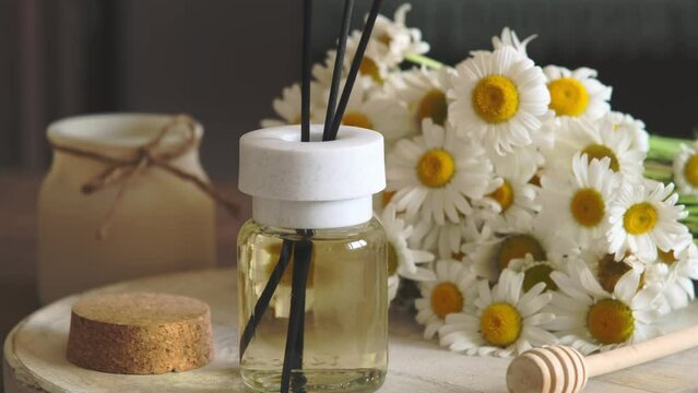 Chamomile flavour air freshener, home aroma fragrance diffuser in bed over. Healthy lifestyle and interior elements