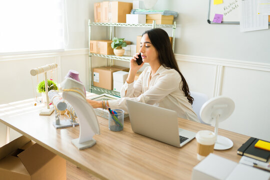 Online seller on the phone working at her office