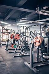 Gym, equipment and weights of fitness background for exercise, training or heavy workout for strength building and wellness. Empty health club of interior space and machines or tools for exercising