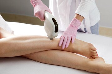 Obraz na płótnie Canvas Laser hair removal on ladies legs in beauty salon