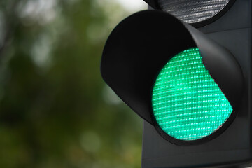 Closeup view of green traffic light in city. Space for text