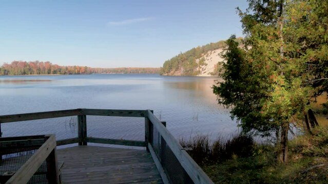 Au Sable River in Michigan during fall colors with gimbal video walking along pathway.