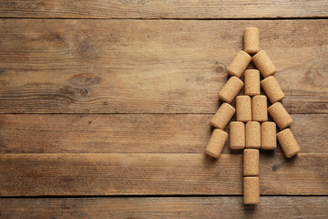 Christmas tree made of wine corks on wooden table, top view. Space for text