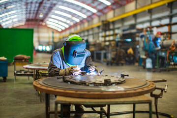 Welding arc argon worker male repaired metal is welding sparks industrial construction repair plate