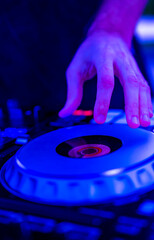 Obraz premium DJ Hands creating and regulating music on dj console mixer in concert