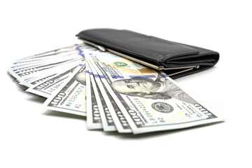 Cash from one hundred dollar bills in a wallet on a white background. A lot of US dollars in a black wallet.