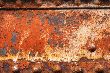 Background with rusty metal beams and powerful rivets. Old bridge mounts.