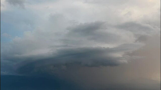 Arcus storm over lake. Landscape of Lake Geneva, mountains and sky at sunset. Dramatic sky. Arcus cloud. Storm cloud. Real time. Lausanne, Switzerland.
