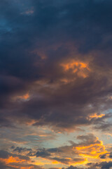 Dramatic clouds at sunrise. Partly cloudy sky vertical background photo