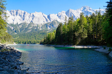 hiking trail overlooking picturesque turquois alpine lake Eibsee (yew lake) by the foot of mountain Zugspitze in Bavaria (the German Alps, Garmisch-Partenkirchen, Grainau, Bavaria, Germany)