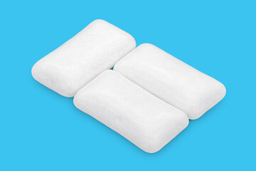Three pieces of white chewing gum isolated on white. The whole subject is in focus.