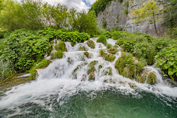 Majestic view of waterfall with crystal clear water in forest in The Plitvice Lakes National Park...
