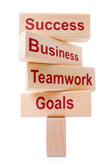 Wooden blocs with words Goals, Teamwork, Business, Success. Concept of business success