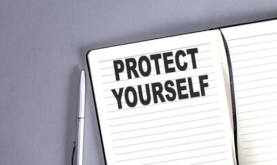 PROTECT YOURSELF word on the notebook with pen