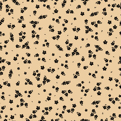 Cute floral pattern. Seamless vector texture. An elegant template for fashionable prints. Print with small black flowers and  leaves. beige background.