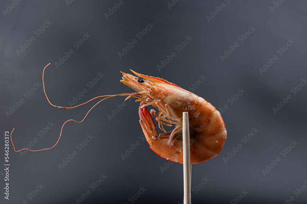 Wall mural Roasted shrimp on black background