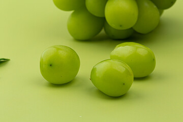 A bunch of Shine Muscat green grape on green background