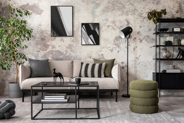 Obraz na płótnie Canvas Interior design of concrete living room with mock up poster frame, gray sofa, pillows, simple coffee table, vase with dried flowers, plants in flowerpot and personal accessories. Home decor.Template.