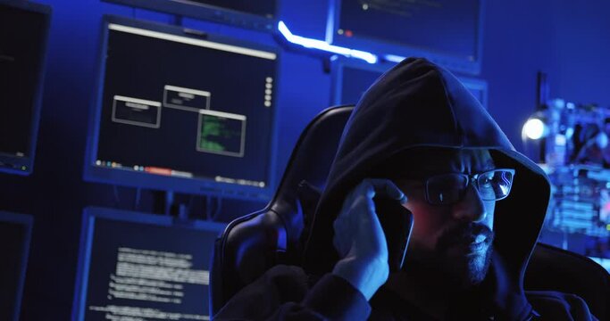A male hacker is using a computer to hack data to demand ransom from victims.
