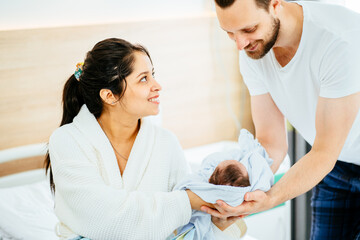 A newborn baby boy with family, A Mother and father with her newborn baby at the hospital a day after a natural birth labor.