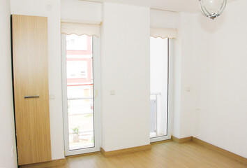 interior design of the apartment with white walls and brown floor