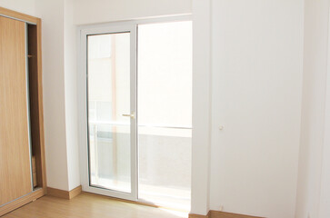 interior design of the apartment with white walls and brown floor