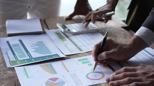 Asian business adviser meeting to analyze and discuss the situation on the financial report in the meeting room.Investment Consultant,Financial Consultant,Financial advisor and accounting concept