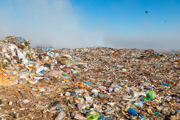 Burning trash piles in landfill